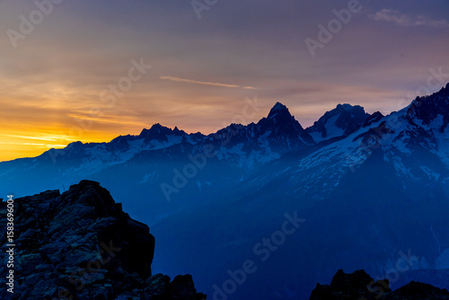 Beautiful mountain landscapes of the Alps on Tour du Montblanc hike. Green valley, snow summits and rocky peaks of Aiguilles de Chamonix and Montblanc. Summer sunny weather blue sky, trekking Alp hike