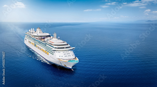 Fototapeta Naklejka Na Ścianę i Meble -  Aerial front view of a generic cruise ship sailing with speed over calm ocean with copy space