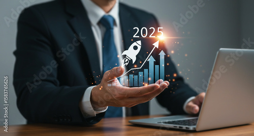 Businessman presents 2025 growth with a virtual rocket and upward-pointing financial chart
