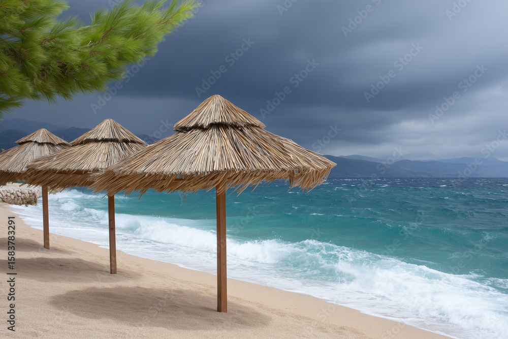 Fototapeta premium Beach parasols on sandy beach with scenic ocean under stormy sky