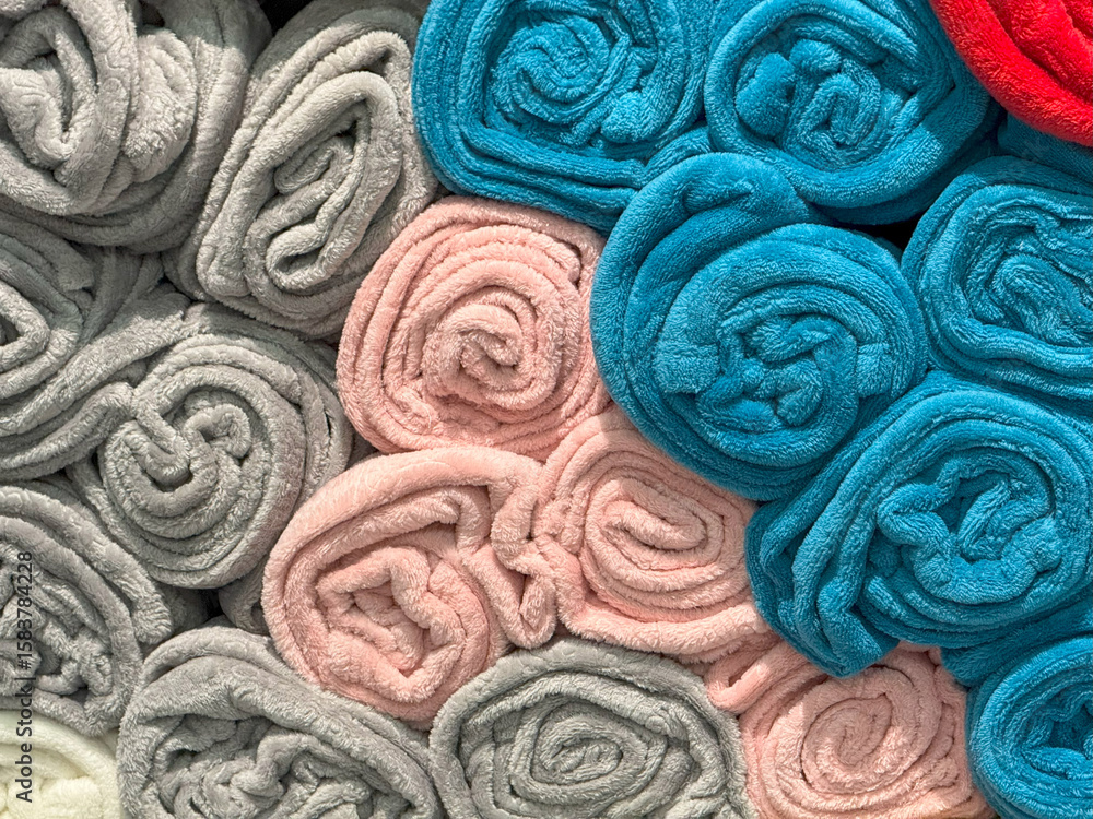 Fototapeta premium Rolled Towels in Multicolor Rows,Shelf Display with Soft Texture Harmony