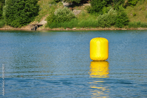 yellow buoy on the surface of the water