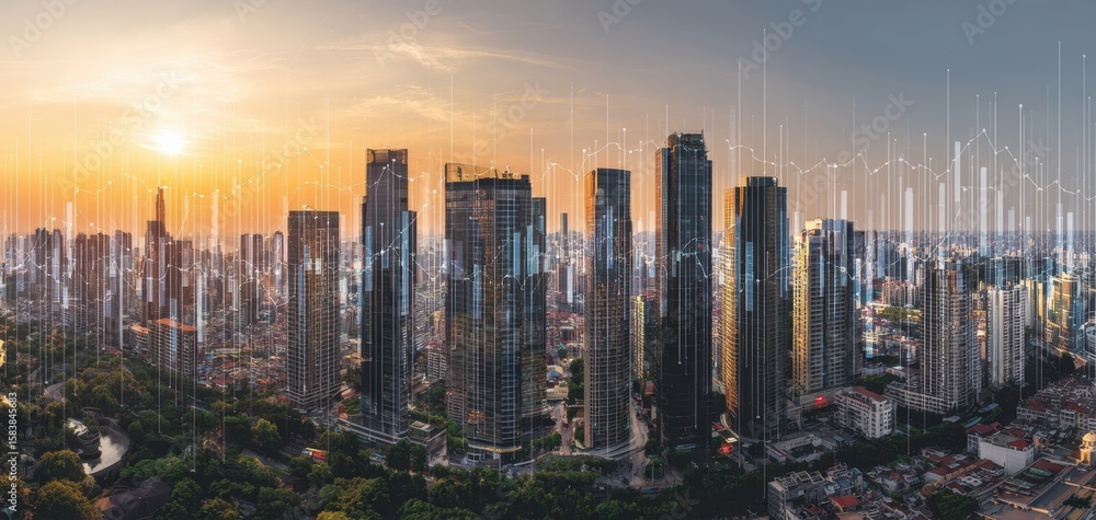 Fototapeta premium The urban skyline illuminated by sunset with digital financial data visualization.