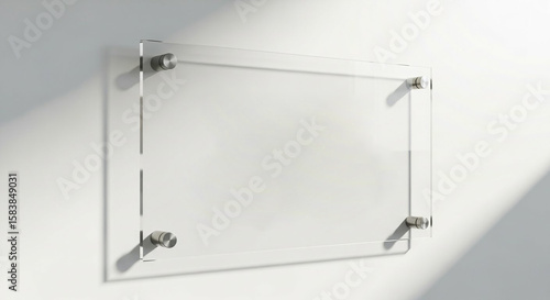Modern clear acrylic sign mounted on a white wall with subtle light and shadow effects
