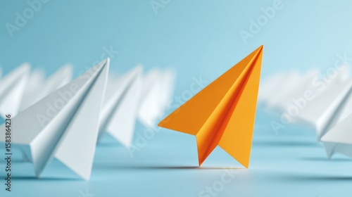 Bright orange paper airplane leads a fleet of white planes on a blue background