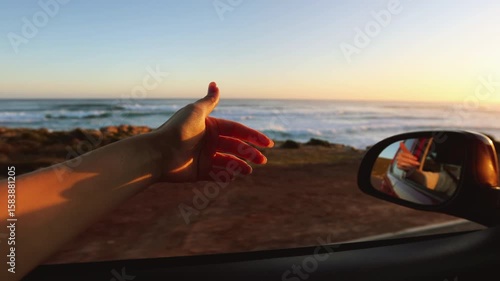 Hand Playing in the Wind Through Car Window on Road Trip