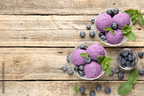 Tasty sorbet with blueberries and mint in dessert bowls on wooden table, flat lay. Space for text