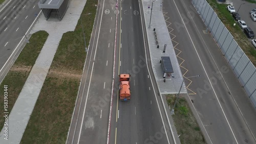 Aerial view of a cleaning machine moves along the highway