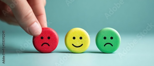 The hand selecting emoticons to express different emotional responses