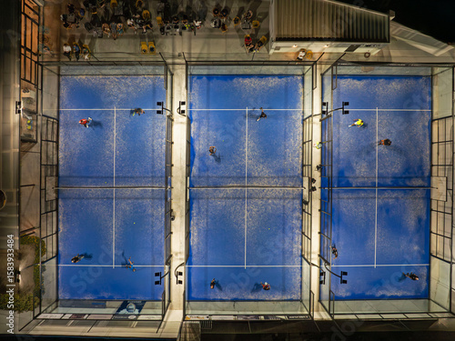 Aerial View of Night Padel Matches on Blue Courts