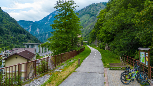 Scenic aerial view of Ciclovia Alpe Adria through Pietratagliata and gorge, Italy – bridges, turquoise river, mountain village, toll road