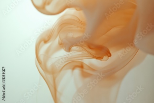 Abstract image showing delicate, swirling patterns of soft peach and beige hues against a subtle, light background.