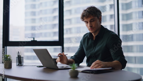 Serious executive working project at modern office closeup. Entrepreneur typing