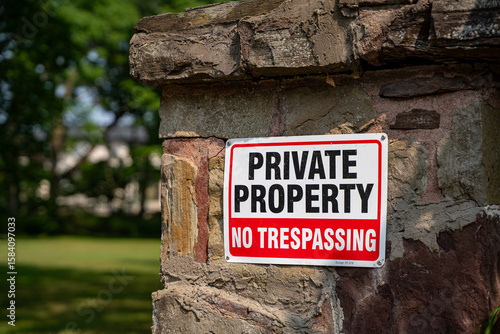 View of private property no trespassing sign at garden entrance.