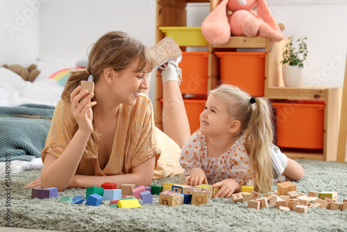 Nanny and little girl playi...