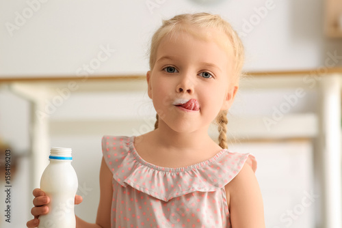 Cute little girl with bottl...
