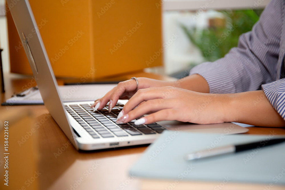 Closeup hand young asian businesswoman checking order of customer for laptop computer, shipment and cargo, retail with online seller and store, startup or small business, shipping and inventory. Closeup hand young asian businesswoman checking order of customer for laptop computer, shipment and cargo, retail with online seller and store, startup or small business, shipping and inventory.