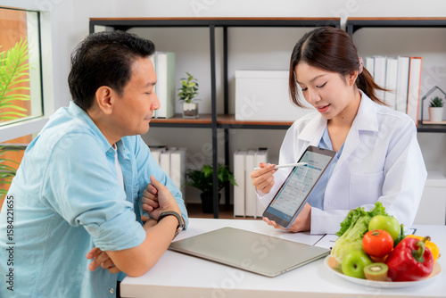 Wallpaper Mural Asian nutritionist using tablet to explaining personalized meal plan with AI to patient during healthcare consultation, healthy lifestyle, woman dietitian showing nutrition plan with AI on tablet. Torontodigital.ca