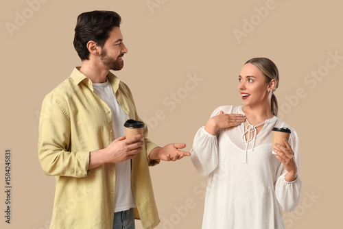 Young couple with coffee cu...