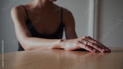 Wallpaper Mural Elegant Hand on Wooden Table with Soft Lighting in Modern Setting Torontodigital.ca