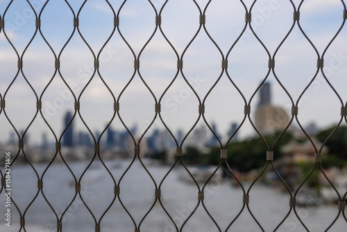 Wallpaper Mural Chao Phraya River and Bangkok city form a blurred background through a wire fence on the Chao Phraya Sky Park Bridge Torontodigital.ca