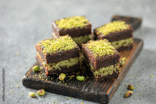 Trend dessert. Dubai Brownies. Chocolate muffin with a layer of pistachio paste and kataifi dough