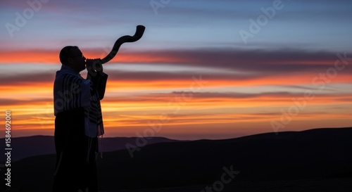 Silhouette of a man blowing a shofar against a vibrant sunset backdrop, Blowing of the Shofar - A solemn moment of tradition amidst the stunning hues of twilight