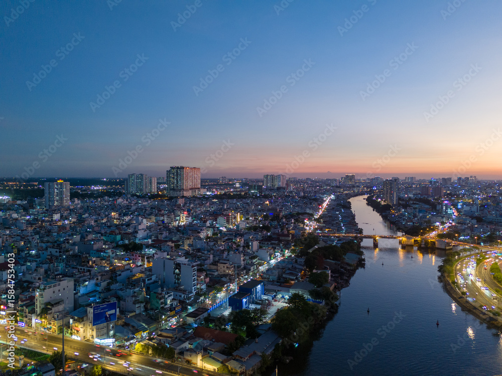 Fototapeta premium Panoramic view of Saigon, Vietnam from above at Ho Chi Minh City's central business district. Cityscape and many buildings, local houses, rivers. Landscape concept.