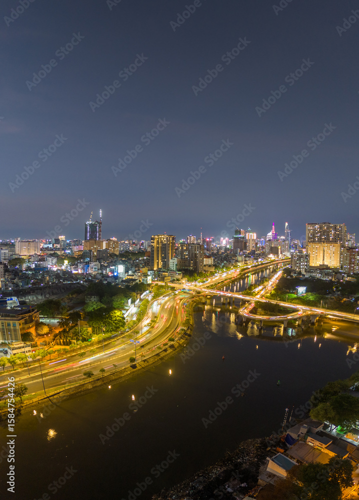 Fototapeta premium Panoramic view of Saigon, Vietnam from above at Ho Chi Minh City's central business district. Cityscape and many buildings, local houses, rivers. Landscape concept.