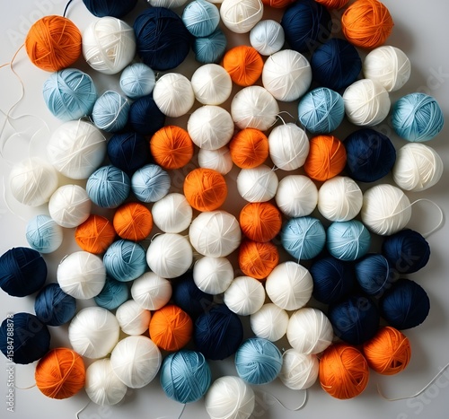 Flat Lay of Knitting Yarns in Orange, Navy, White, and Blue Tones with Vertical Center Spool