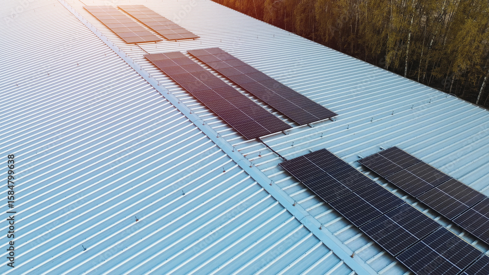 Fototapeta premium Solar panel array on large warehouse structure