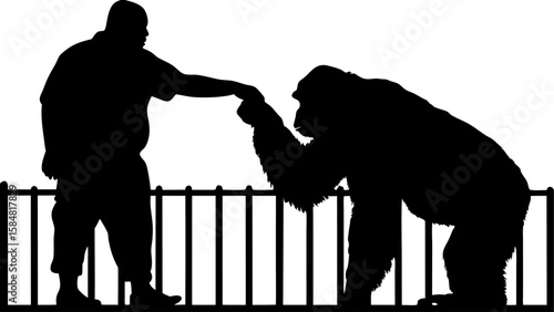 Silhouette of a man reaching out to touch a gorilla's hand over a metal fence in black and white