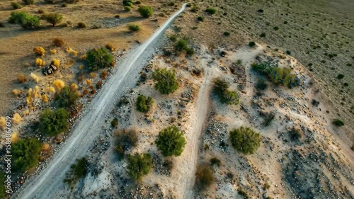 Aerial view showcasing winding dirt roads and vegetation in the Yuma Desert during daytime, Aerial view of Yuma Desert