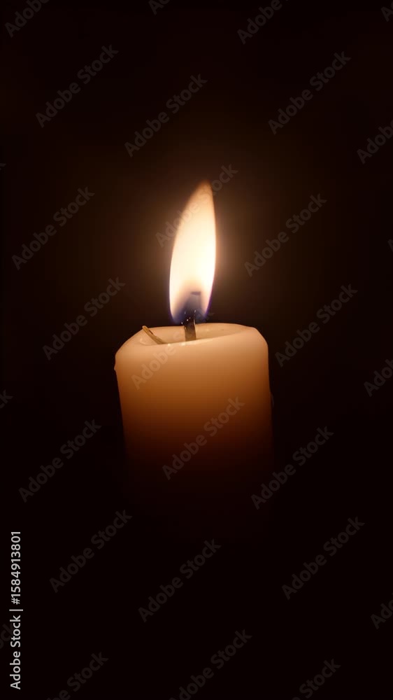 Burning candle on black background Burning candle on black background