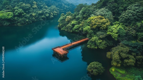 Fototapeta Naklejka Na Ścianę i Meble -  Fishing pier on a lake surrounded by lush greenery