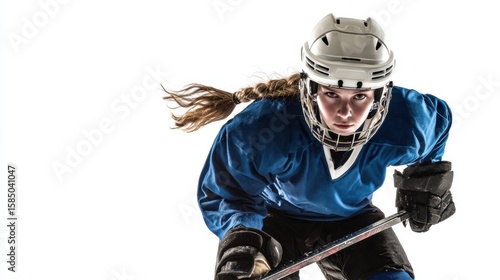 The determined young female hockey player in action on the ice.