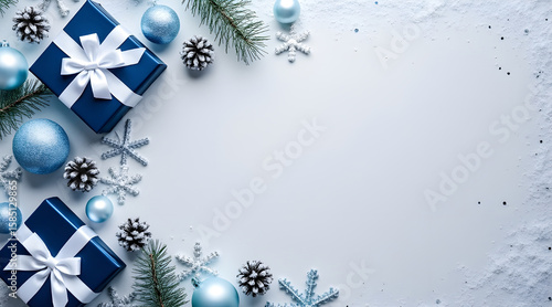 Festive arrangement of blue christmas gifts adorned with white ribbons surrounded by sparkling ornaments pine cones and snowflakes on a light background