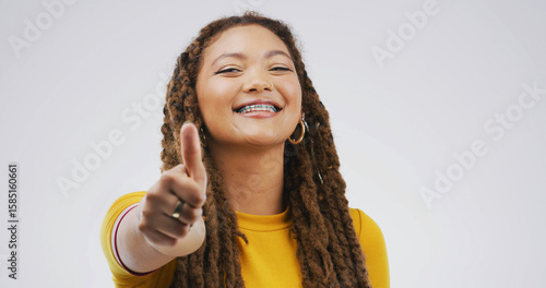 Papier peint Black woman, braces and thumbs up in studio for approval feedback and emoji on white background