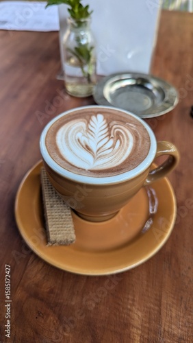 High angle view of coffee cup on table and wafer