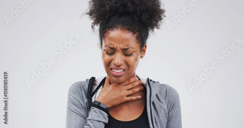 Foto Upset, sick or black woman with itchy throat on studio space for cold, sore voice or virus symptoms