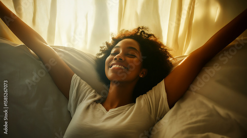 Joyful young African woman enjoying morning light in a cozy indoor setting with soft textures and uplifting mood
