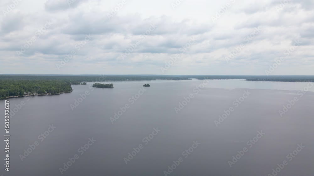Aerial shot over Lake Calabogie with green forest covered islands throughout. Calabogie ski hill. Ontario Canada Aerial shot over Lake Calabogie with green forest covered islands throughout. Calabogie ski hill. Ontario Canada