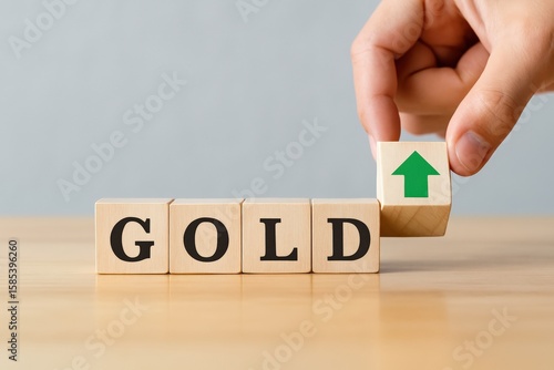 Rising Gold Investment is symbolized by wooden blocks, where an upward-pointing arrow signifies portfolio growth and financial aspiration for a prosperous future.