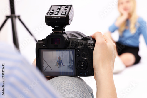 Quadro su tela Photographer working with model in professional photo studio, selective focus