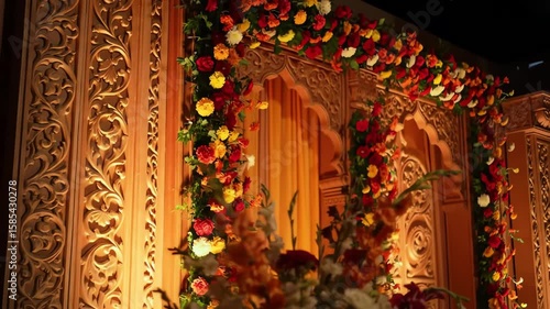 A beautifully decorated Indian wedding mandap with vibrant flower arrangements and elegant traditional design.
