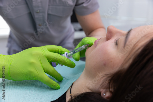 A Close-Up of a Cosmetic Procedure: Injecting Filler into Lips with Precision and Care by a Skilled Professional in a Modern Medical Setting