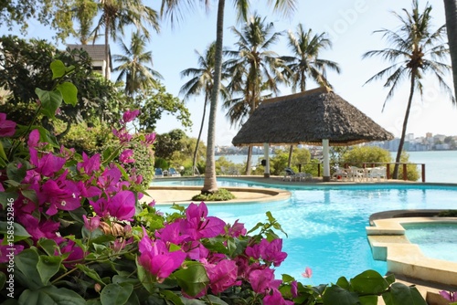 Tropical Hotel Pool with Azaleas and Palms by the Ocean in Mombasa, Kenya