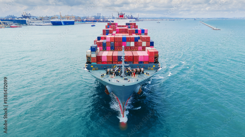 Fototapeta premium Front Cargo Container ship the ocean ship carrying container and running for import export concept technology freight shipping by ship. Container Vessel running out from international customs.