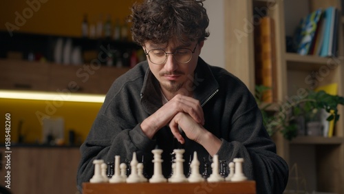 Obraz na płótnie Pensive Hispanic guy man playing chess hipster hobby tournament at home male pla