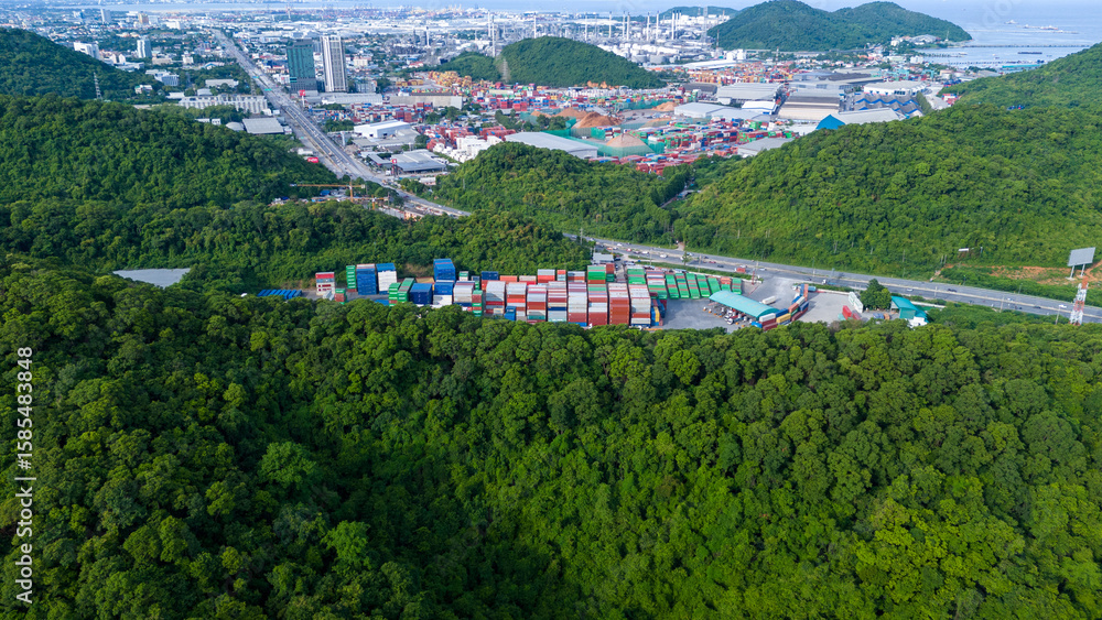 Obraz premium green transportation. Cargo Container yard next the road and surrounded by mountains , forklift truck and cargo at depot working shipping green logistics